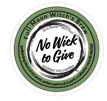 A circular product label for 'Full Moon Witch's Brew' wickless soy candles. The label features a sage green outer ring with black text, a white center, and a black circular brushstroke design in the middle containing the phrase 'No Wick to Give'.