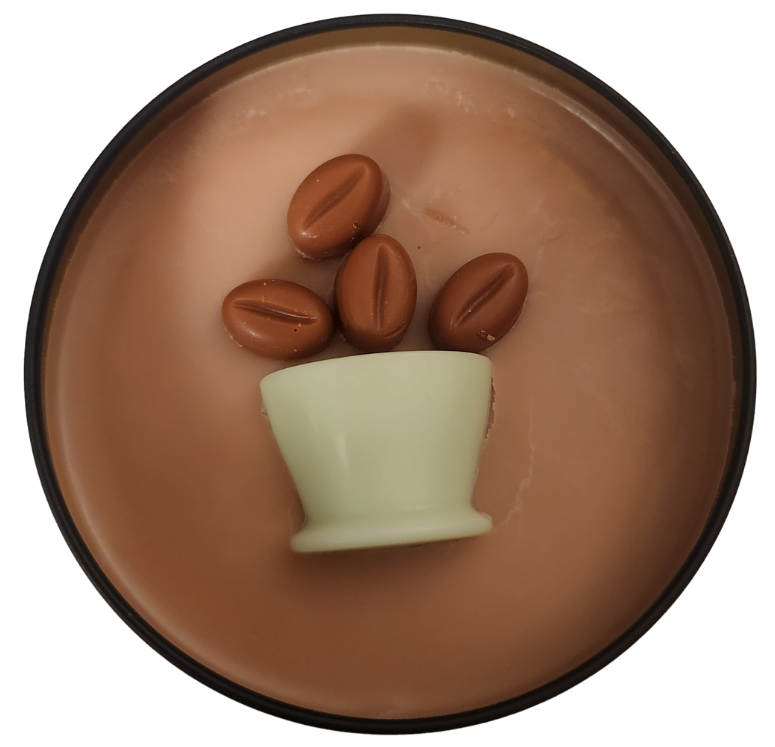 A black candle tin with tan wax and a green wax coffee mug with brown wax coffee beans coming out of the mug on a transparent background.