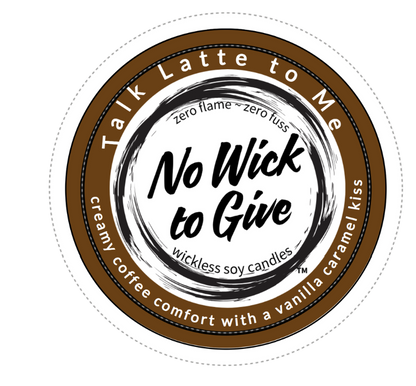 A round wax melt packaging label or sticker for 'No Wick to Give' soy candles, featuring a brown and white design with the scent description 'creamy coffee comfort with a vanilla caramel kiss'.
