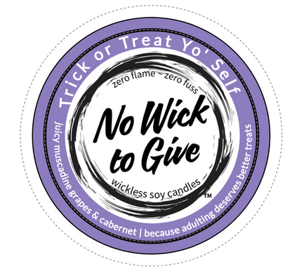 A circular product label for 'No Wick to Give' soy candles, featuring a purple outer ring with white text and a black brushstroke center on a white background.